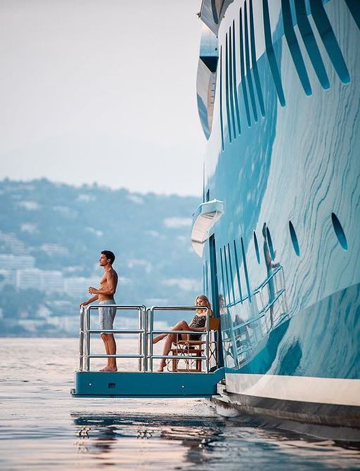 A couple enjoy their morning coffee as they overlook the Mediterranean from the comfort of charter yacht sunrays