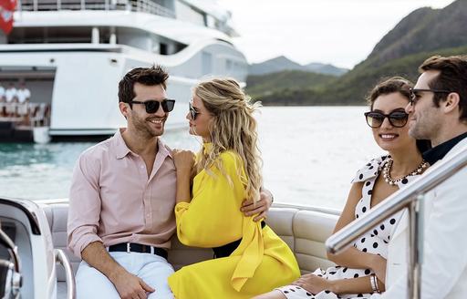 a group of young couples enjoying their ride on to the shores of the amalfi coast while on their luxury yacht charter through the Mediterranean 