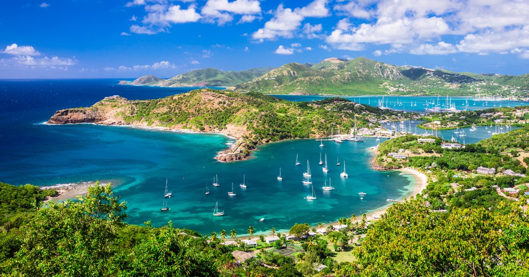 Yachts anchored in a sheltered cove in Antigua Harbor, Caribbean