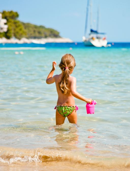 Child playing in the sea during a yacht charter in Croatia