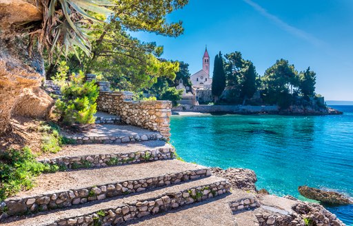 Idyllic harbor in Croatia with stone steps in the foreground