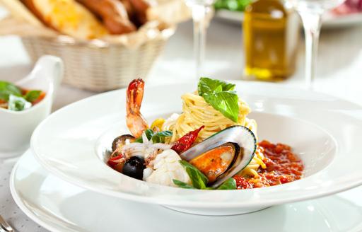 Fresh pasta and shellfish on dining table, classic Italian cuisine 