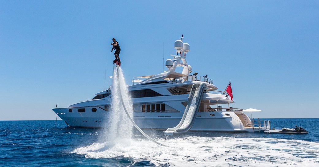 a man using the on board water toys of the luxury yacht he is chartering through the Mediterranean 