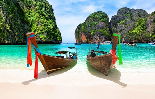Beautiful beach with Thai traditional wooden long-tail boat and blue sky in Maya bay, Thailand
