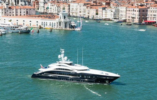 a motor yacht crusiing the coast of Venice while on a luxury yacht charter in Italy