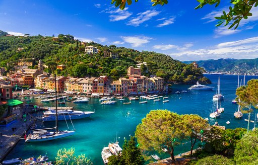 motor yachts and sailing yacht anchored in charter location portofino,italy