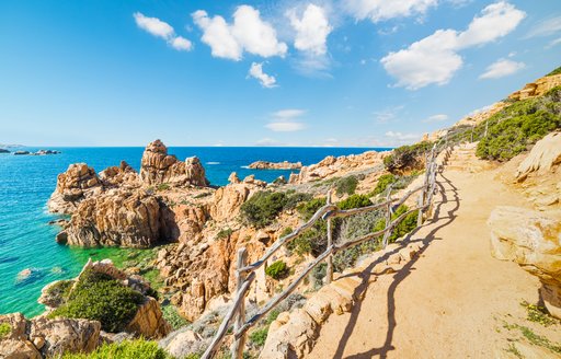 a rocky path on the coast of a popular yacht charter destination sardinia 
