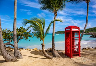 Red phone box on a tropical beach in Antigua, Cariibean