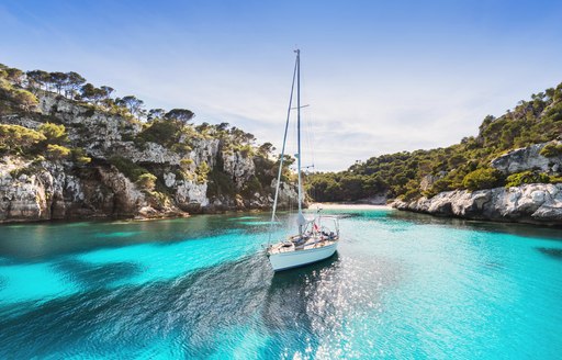 Sailing yacht anchored in turquoise waters in Ibiza