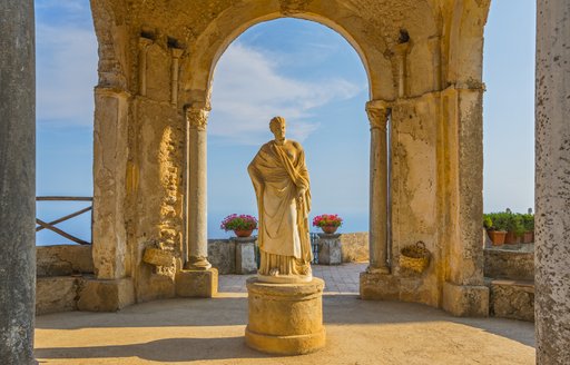 the famous statue of someone in vila cibrone a vacation hostspot that sees masses of guests on a luxury yacht charter through italy come and visit