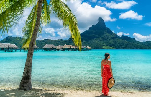 woman looking out into the blue waters of Tahiti