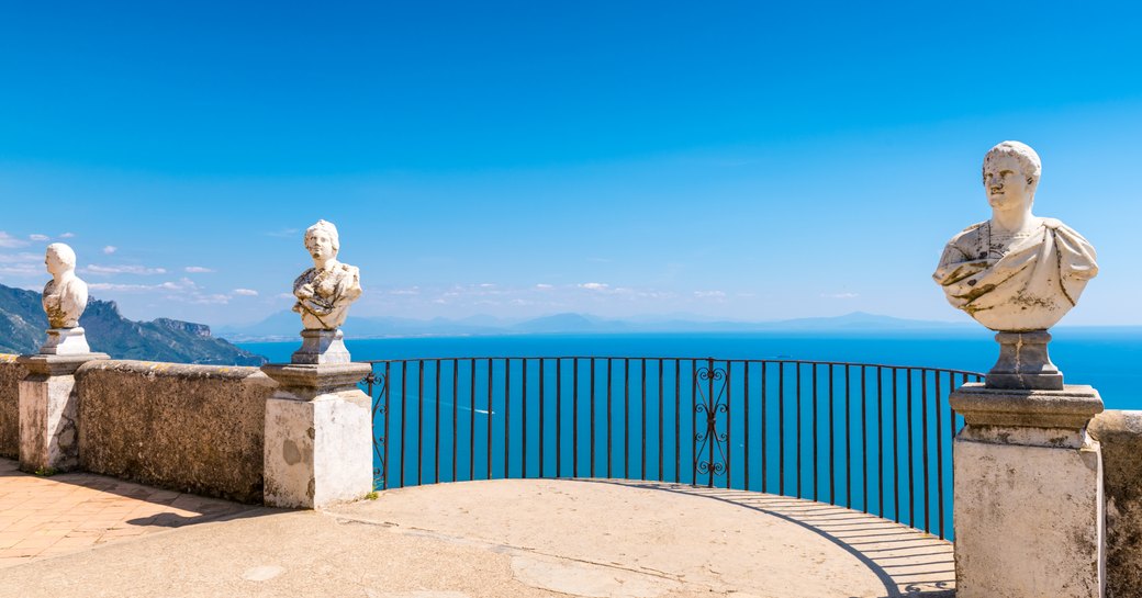 Marble busts line Belvedere of the Villa Cimbrone overlooking Amalfi coast