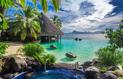 Thatched wooden over-water bungalows in Moorea