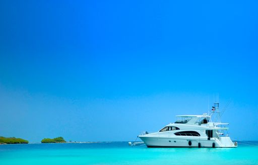 yacht anchored in turquoise water in the maldives